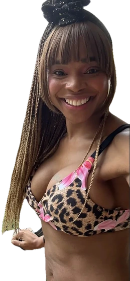 Tina Bean smiling on a sunny balcony.